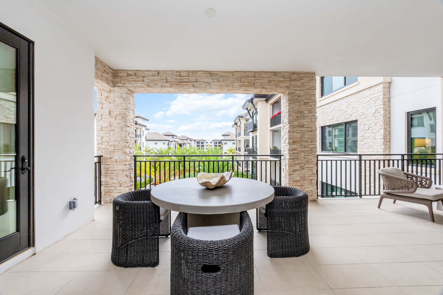 Large balcony with dining and living areas