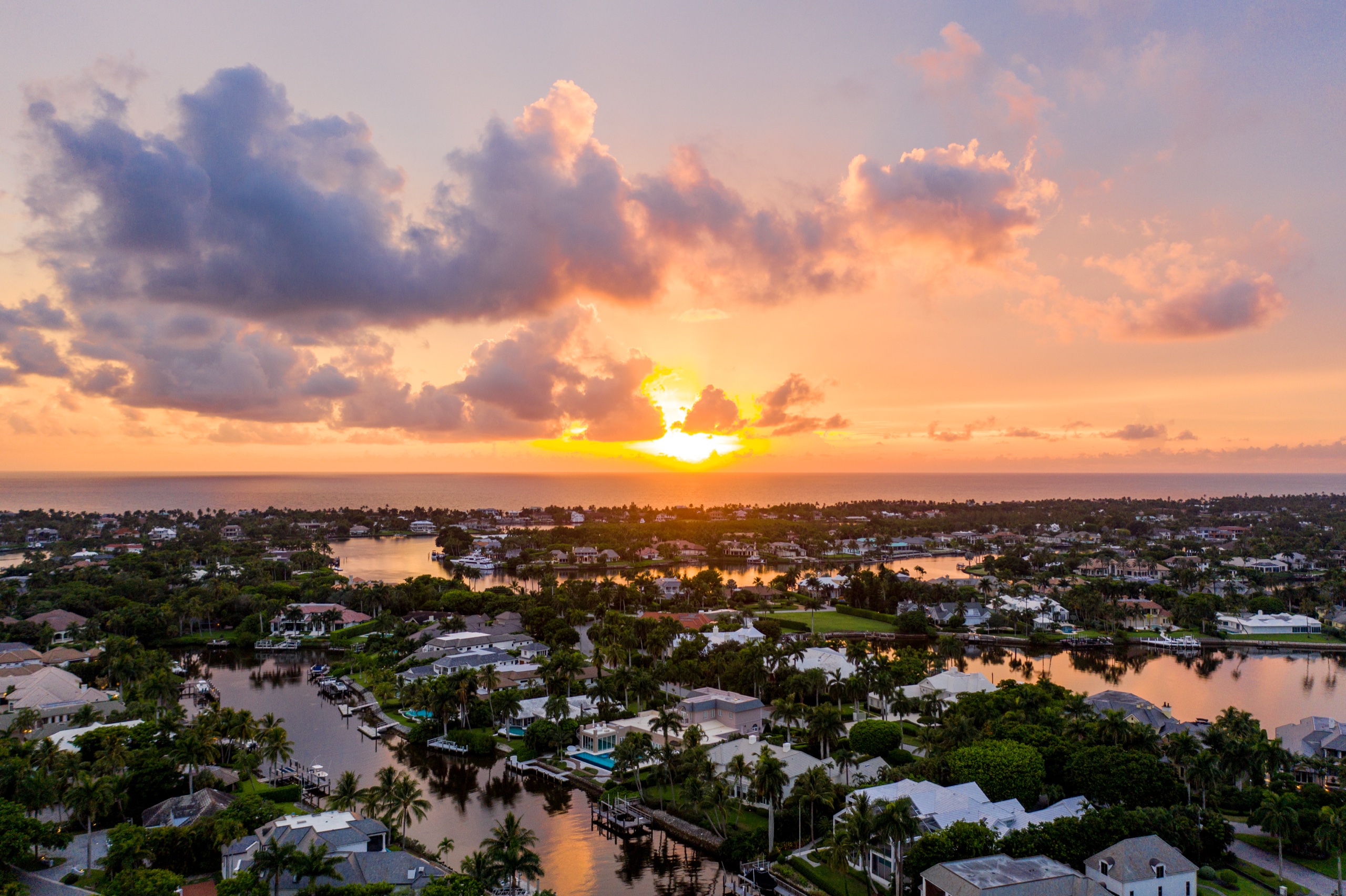 Luxury waterfront estate at golden hour, aerial view — Naples, Florida