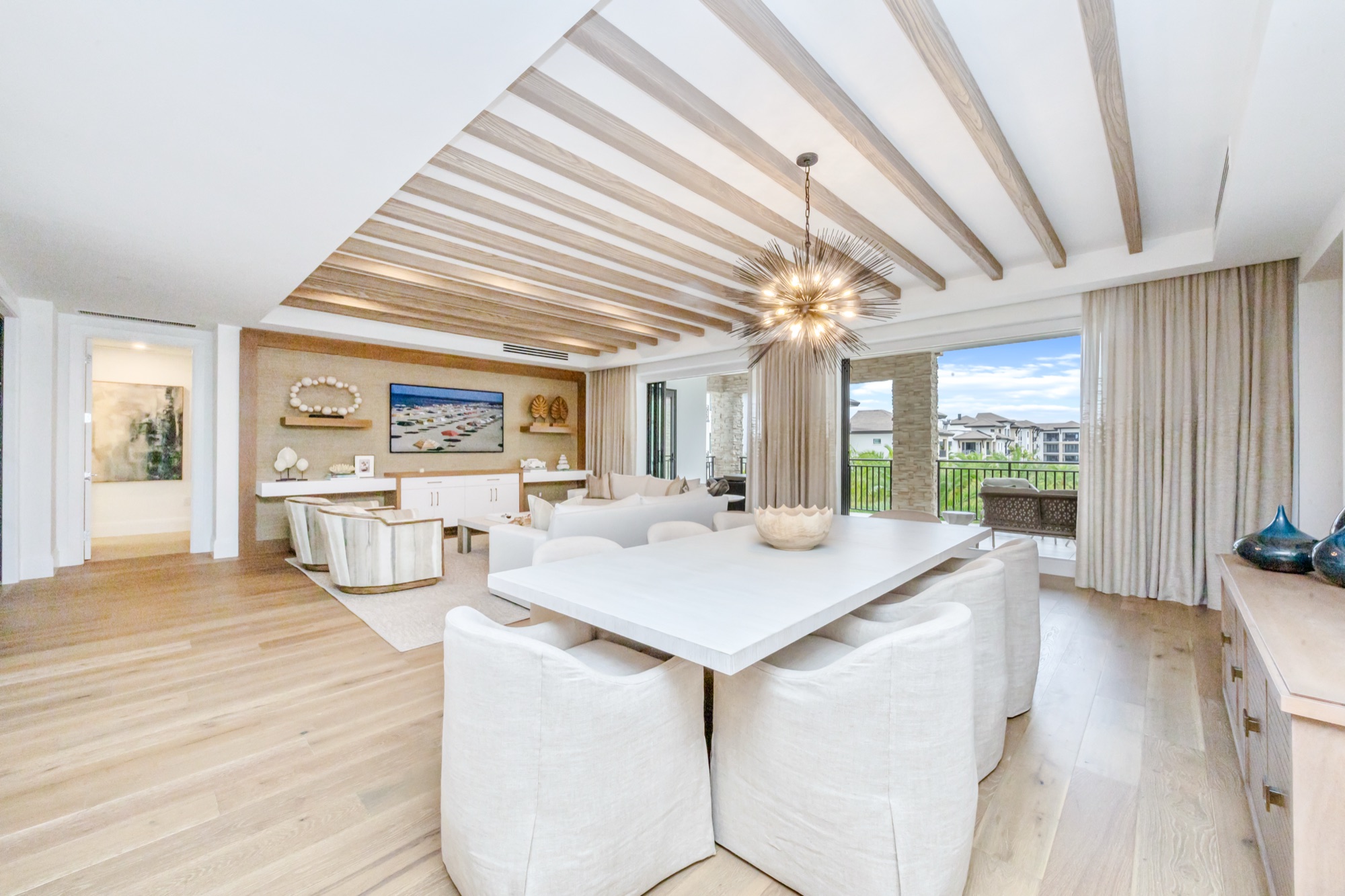 Large open living and dining area with disappearing sliding glass doors — 1130 3rd Ave S